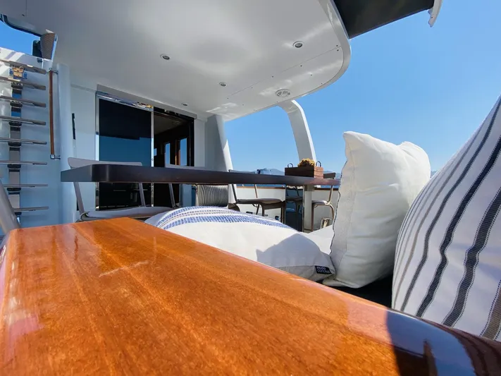  Yacht Photos Pics Luxurious 2014 Ada Yacht Steel Trawler deck with cushions and table under clear blue sky.