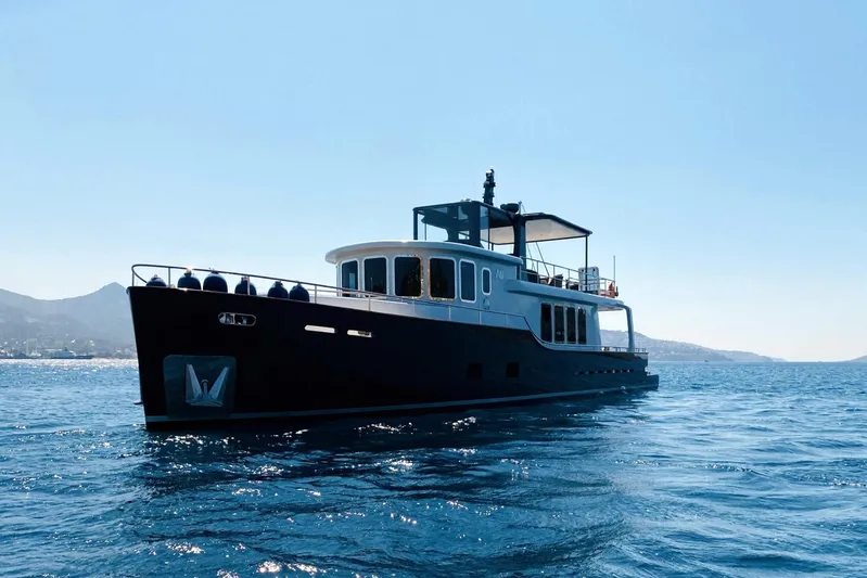  Yacht Photos Pics 2014 Ada Yacht Steel Trawler cruising on open water under clear blue sky.