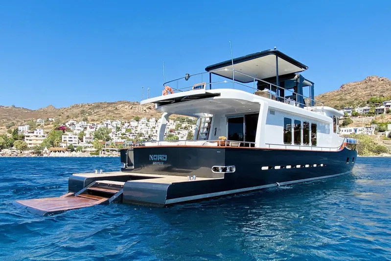  Yacht Photos Pics Ada Yacht Steel Trawler 2014 on serene blue waters with scenic coastal backdrop.