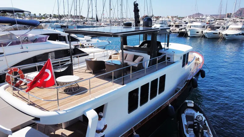 Yacht Photos Pics Luxurious 2014 Ada Yacht Steel Trawler docked in a marina, featuring spacious deck and Turkish flag.