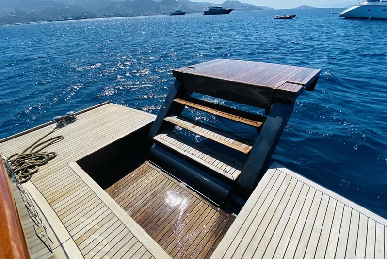  Yacht Photos Pics Luxury yacht deck with retractable stairs, Ada Yacht Steel Trawler 2014, on serene blue waters.