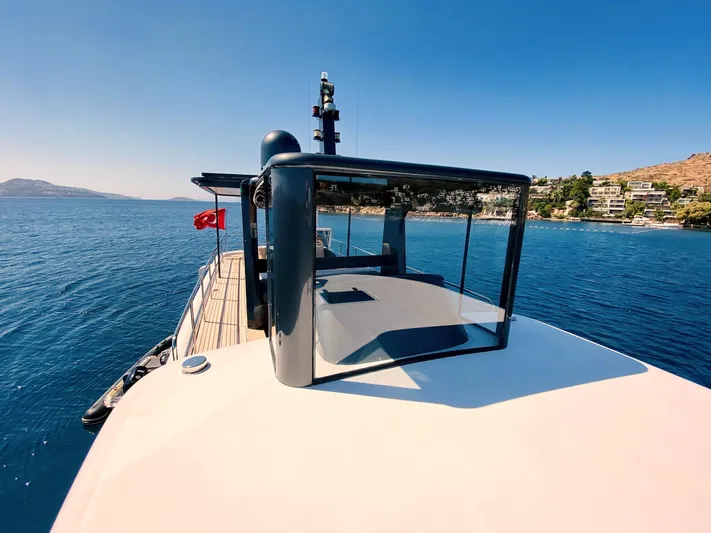  Yacht Photos Pics Ada Yacht Steel Trawler 2014 cruising on clear blue waters near a coastal town.