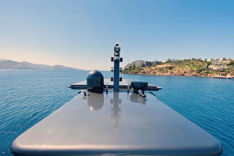  Yacht Photos Pics Ada Yacht Steel Trawler 2014 cruising on serene blue waters near a coastal landscape.