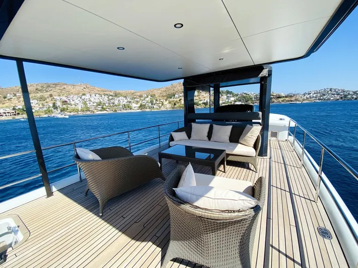  Yacht Photos Pics Luxurious 2014 Ada Yacht Steel Trawler deck with elegant seating, overlooking serene blue waters.
