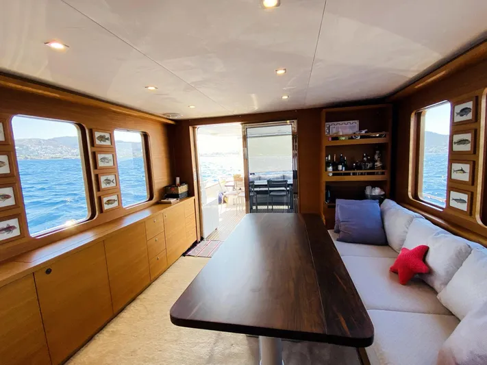  Yacht Photos Pics Interior of 2014 Ada Yacht Steel Trawler with ocean view, wooden decor, and cozy seating.
