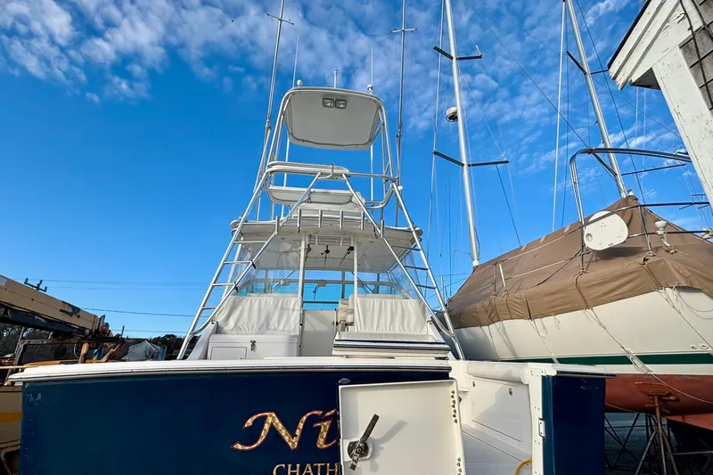 Niala Yacht Photos Pics 2004 Cabo 35 Express Sportfish boat docked under clear blue sky.