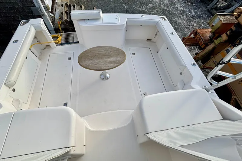 Niala Yacht Photos Pics 2004 Cabo 35 Express Sportfish boat deck with seating and a central table.