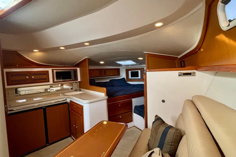 Niala Yacht Photos Pics Luxurious interior of 2004 Cabo 35 Express Sportfish with kitchen and sleeping area.