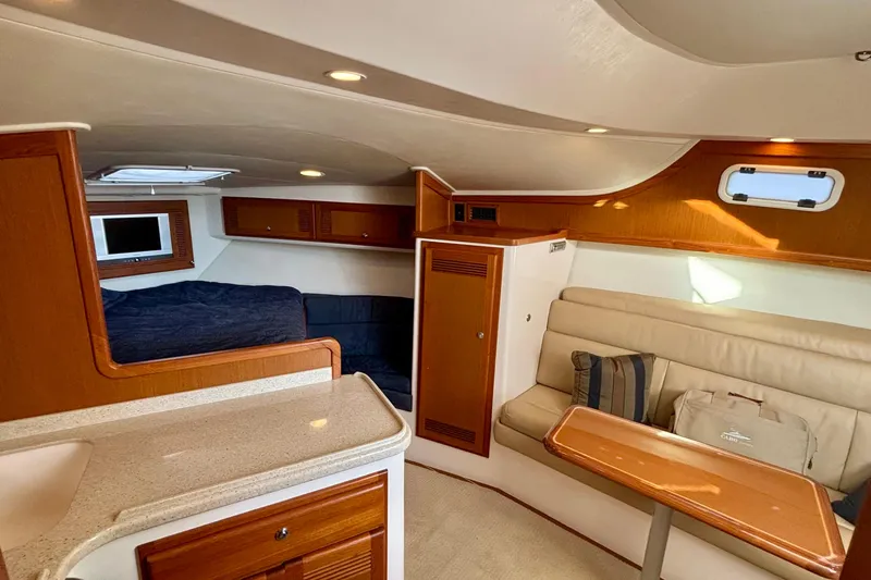 Niala Yacht Photos Pics 2004 Cabo 35 Express Sportfish interior with cozy seating and modern amenities.