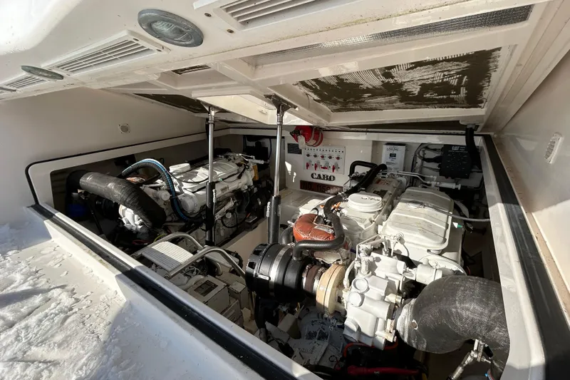Niala Yacht Photos Pics Engine compartment of 2004 Cabo 35 Express Sportfish, showcasing dual engines and mechanical components.