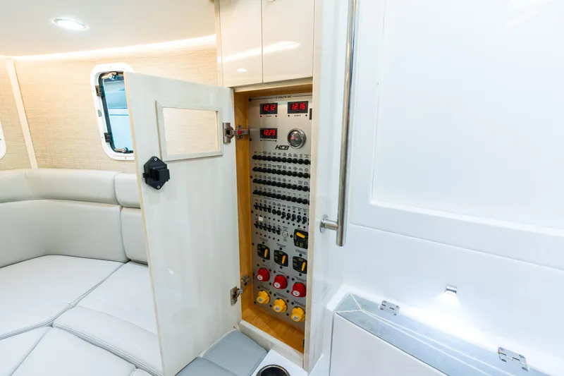  Yacht Photos Pics 2023 HCB 42 Lujo yacht interior with open electrical panel and seating area.