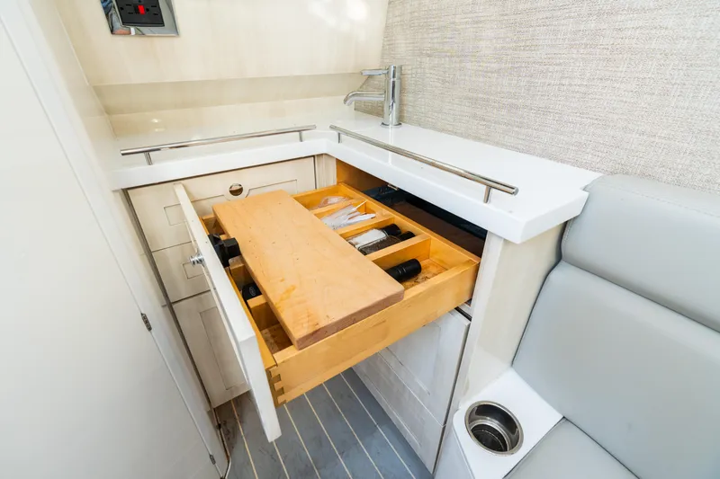  Yacht Photos Pics 2023 HCB 42 Lujo boat interior with open kitchen drawer and cutting board.