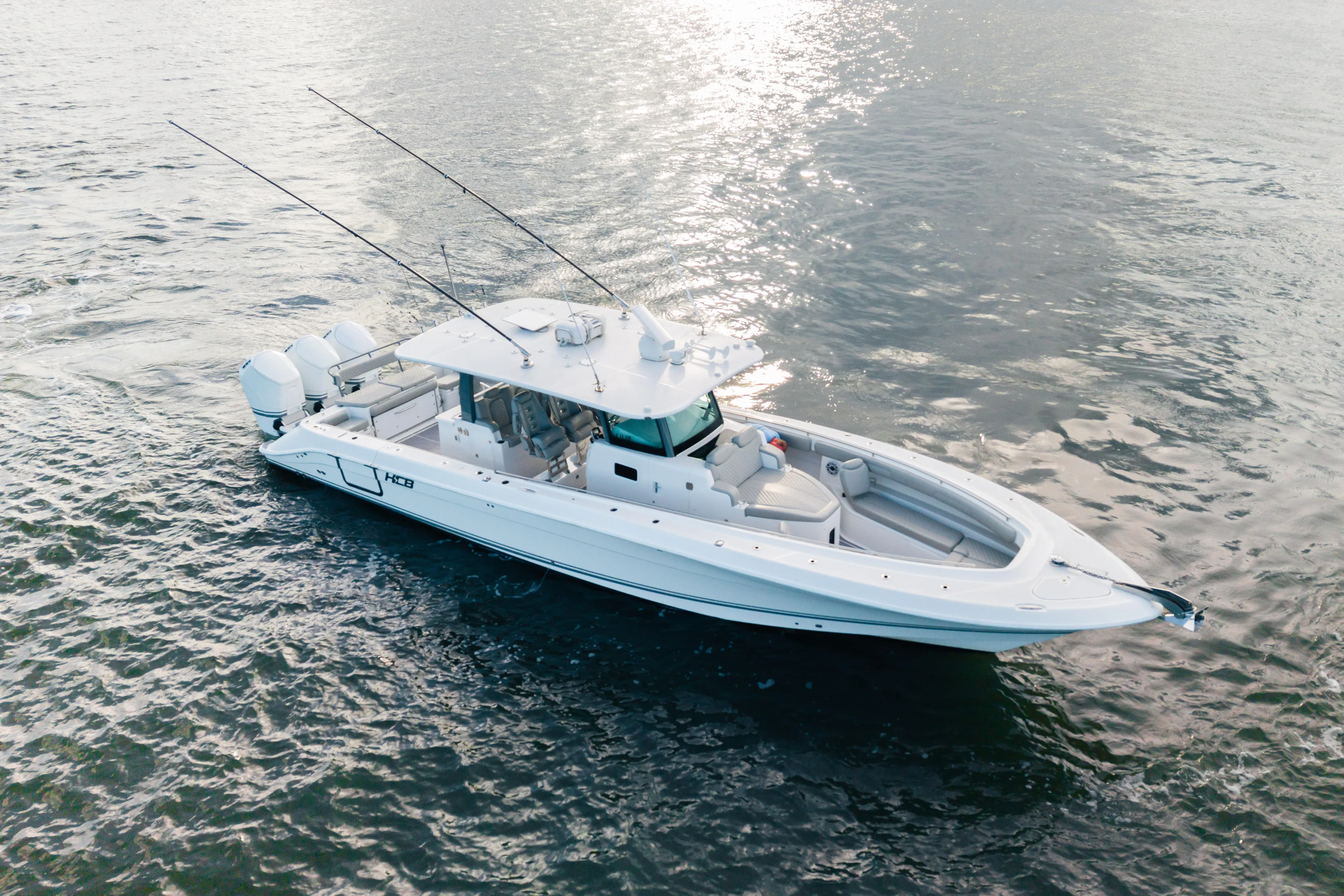  Yacht Photos Pics 2023 HCB 42 Lujo boat on water, featuring sleek design and multiple outboard engines.