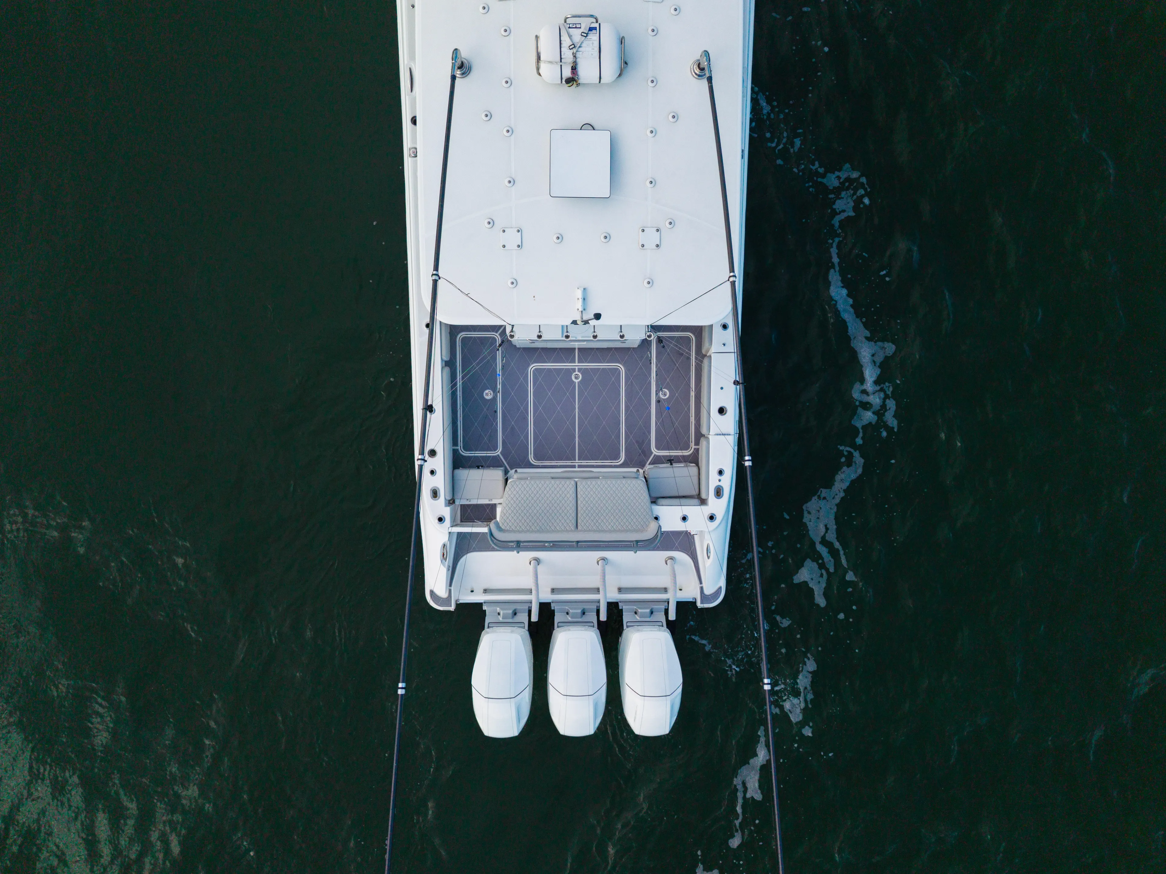  Yacht Photos Pics Aerial view of 2023 HCB 42 Lujo boat with triple outboard engines.