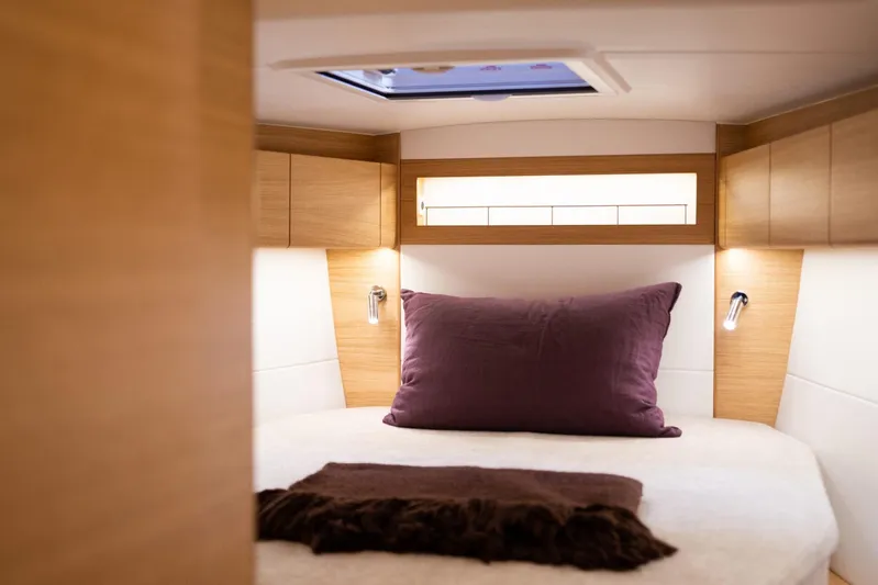  Yacht Photos Pics Luxurious cabin interior of 2025 X-Yachts X4⁶ with cozy bedding and ambient lighting.