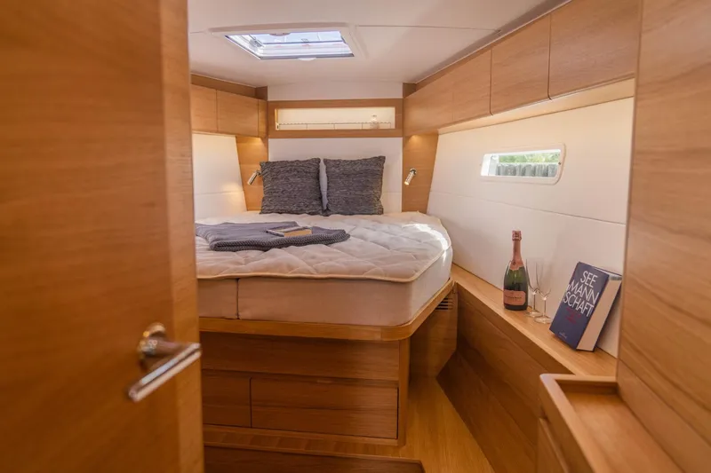  Yacht Photos Pics Luxurious cabin interior of 2025 X-Yachts X4⁶ with cozy bed and elegant decor.