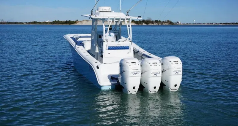  Yacht Photos Pics 2019 Yellowfin 34 boat with triple outboard engines on calm water.