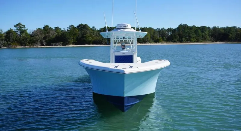  Yacht Photos Pics 2019 Yellowfin 34 boat on calm water with forested shoreline.