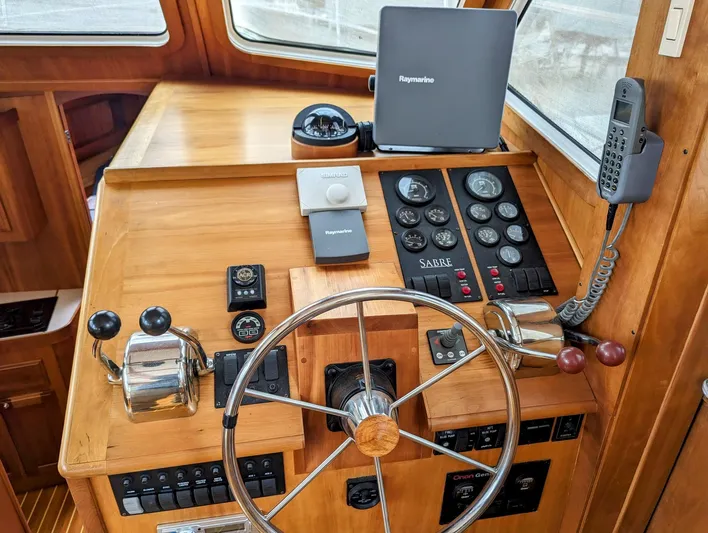  Yacht Photos Pics 2003 Sabre 36 Flybridge helm with steering wheel, controls, and navigation equipment.