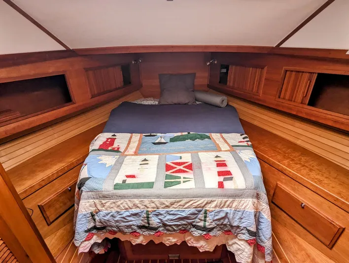  Yacht Photos Pics Cozy cabin interior of 2003 Sabre 36 Flybridge with nautical-themed quilt.