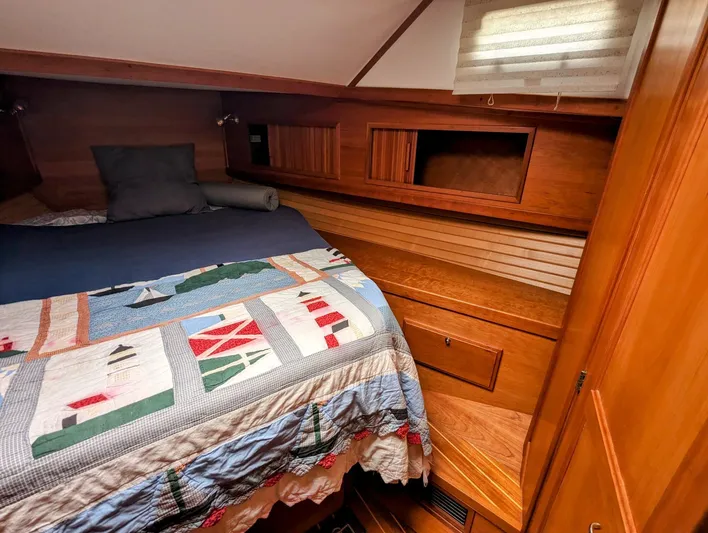  Yacht Photos Pics Cozy cabin interior of 2003 Sabre 36 Flybridge with nautical-themed bedding.