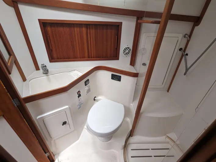  Yacht Photos Pics 2003 Sabre 36 Flybridge bathroom with toilet, sink, and wooden accents.
