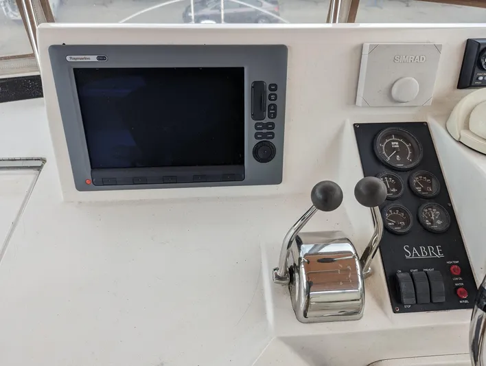  Yacht Photos Pics Control panel of a 2003 Sabre 36 Flybridge with navigation screen and throttle levers.