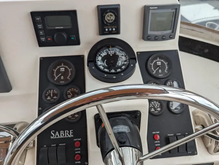  Yacht Photos Pics Control panel of 2003 Sabre 36 Flybridge with gauges and steering wheel.