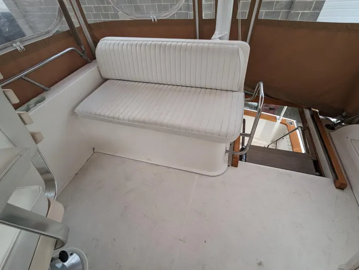  Yacht Photos Pics 2003 Sabre 36 Flybridge interior with white seating and brown accents.