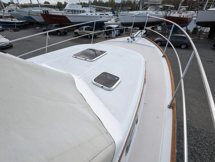  Yacht Photos Pics 2003 Sabre 36 Flybridge yacht deck with hatches, docked among other boats.