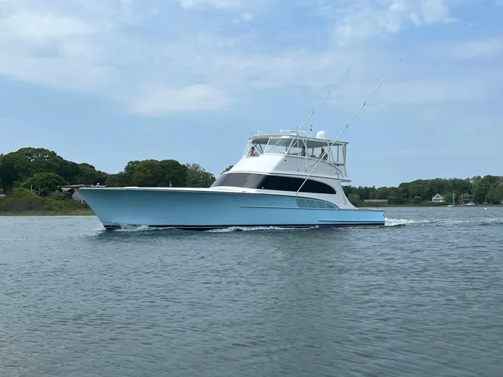  Yacht Photos Pics 2005 Custom Carolina 66 yacht cruising on a calm waterway under a clear sky.