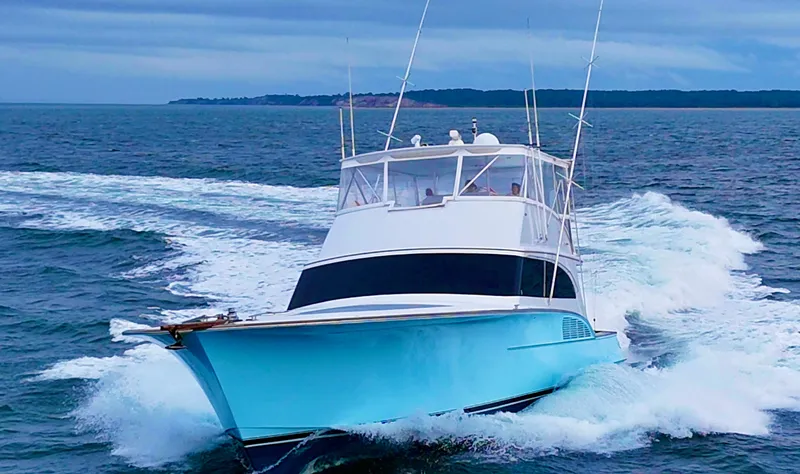  Yacht Photos Pics 2005 Custom Carolina 66 yacht cruising on open water, showcasing sleek design and powerful performance.