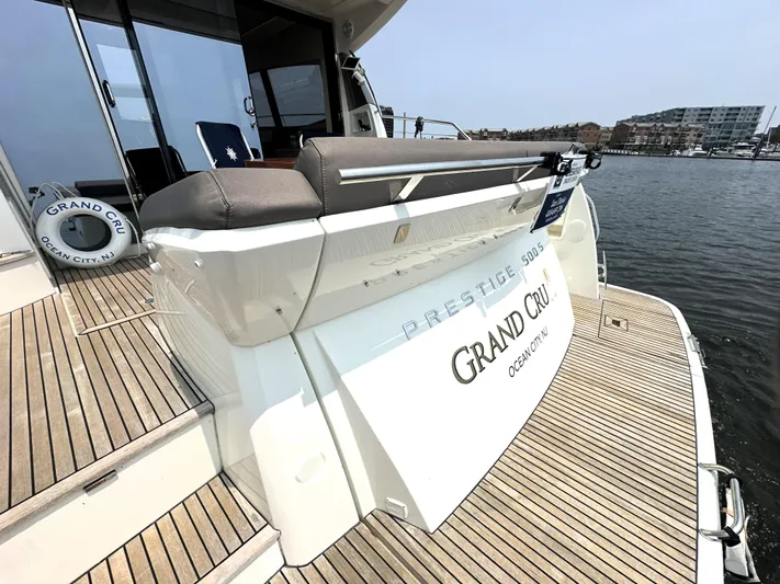 Grand Cru Yacht Photos Pics Luxury yacht Prestige 500 S, 2017 model, docked with wooden deck and "Grand Cru" signage.
