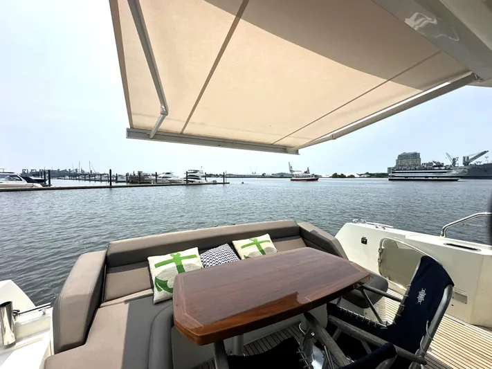 Grand Cru Yacht Photos Pics Luxury yacht deck with seating, table, and awning; Prestige 500 S, 2017 model.