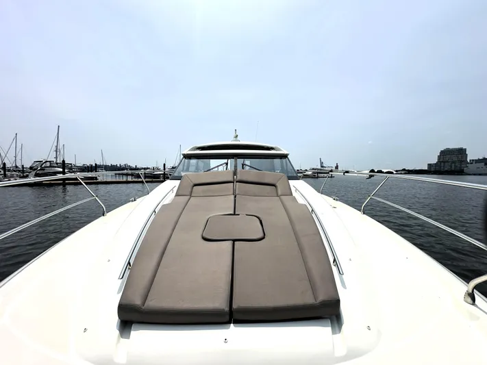 Grand Cru Yacht Photos Pics 2017 Prestige 500 S yacht with sunbed, docked in a marina.