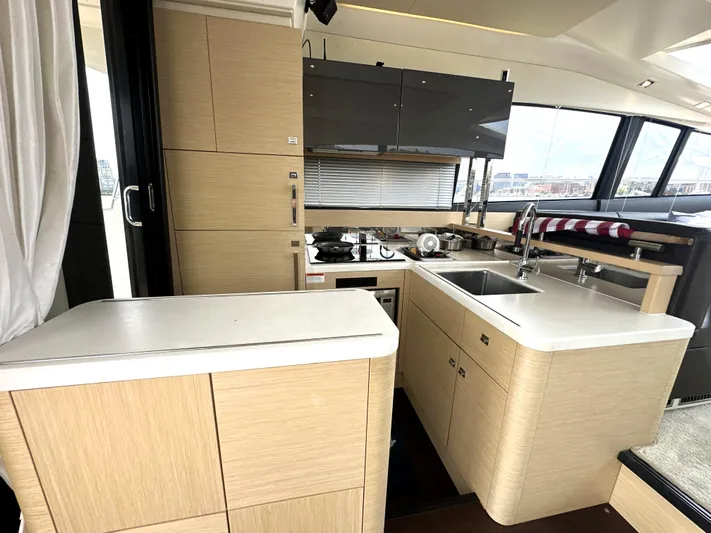 Grand Cru Yacht Photos Pics Modern kitchen interior on a 2017 Prestige 500 S yacht, featuring sleek cabinetry and appliances.
