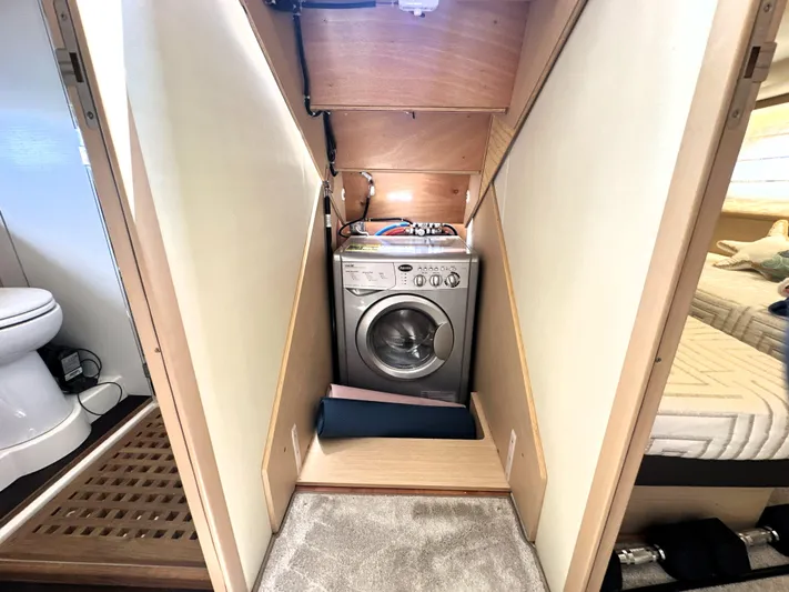 Grand Cru Yacht Photos Pics Laundry area with washing machine in 2017 Prestige 500 S yacht interior.