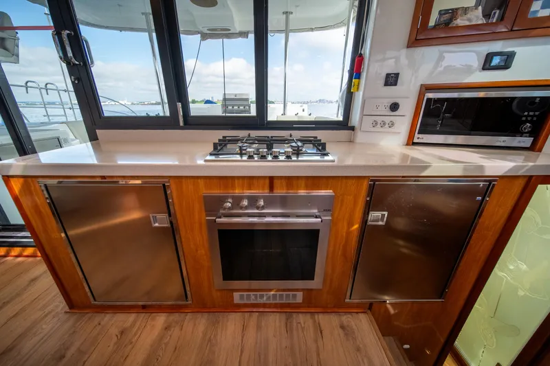 Walkabout Yacht Photos Pics Modern kitchen in 2019 Royal Cape Catamarans Majestic 530 with stove, oven, and sea view.