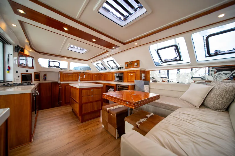Walkabout Yacht Photos Pics Luxurious interior of 2019 Royal Cape Catamarans Majestic 530 with modern kitchen and seating area.
