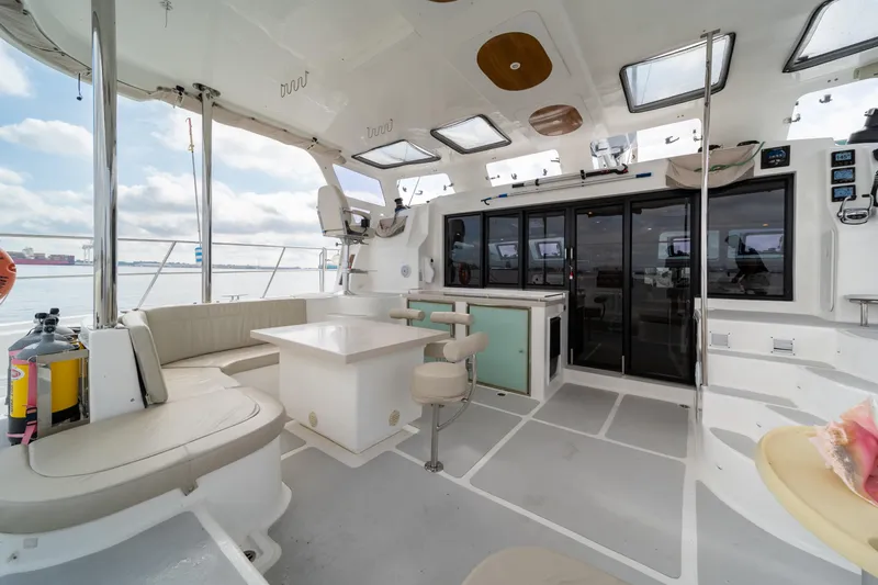 Walkabout Yacht Photos Pics Spacious 2019 Royal Cape Catamarans Majestic 530 interior with seating and navigation area.