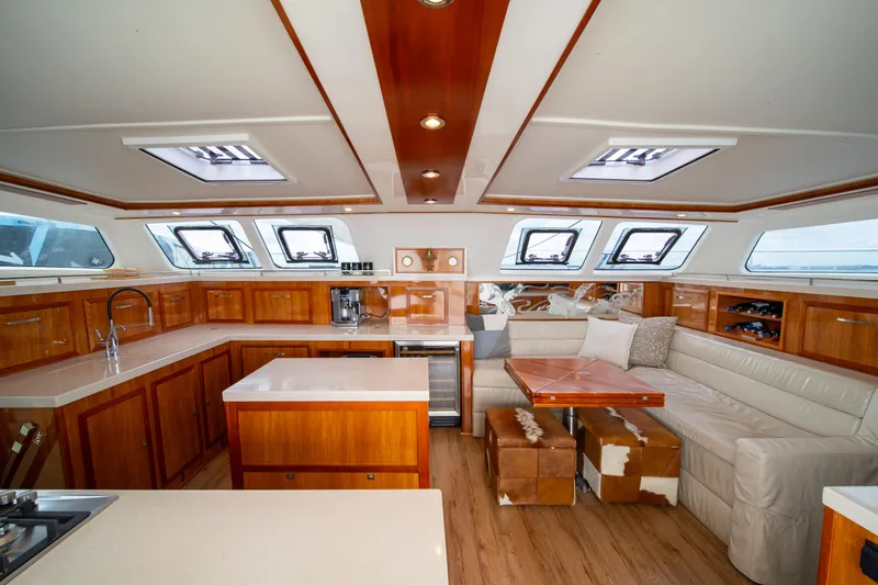 Walkabout Yacht Photos Pics Luxurious interior of 2019 Royal Cape Catamarans Majestic 530 with elegant wood finishes and seating.