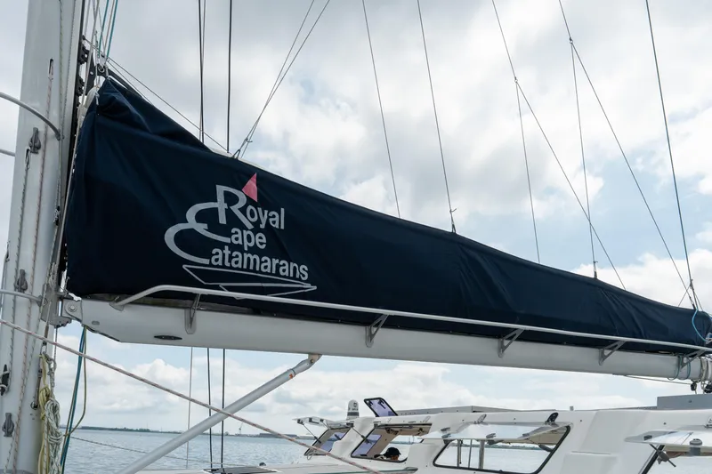 Walkabout Yacht Photos Pics Royal Cape Catamarans Majestic 530 sailboat, 2019 model, with covered boom against cloudy sky.