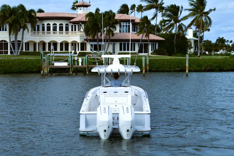 Low Key Yacht Photos Pics Valhalla V-33 boat cruising near luxury waterfront mansion, 2021 model.