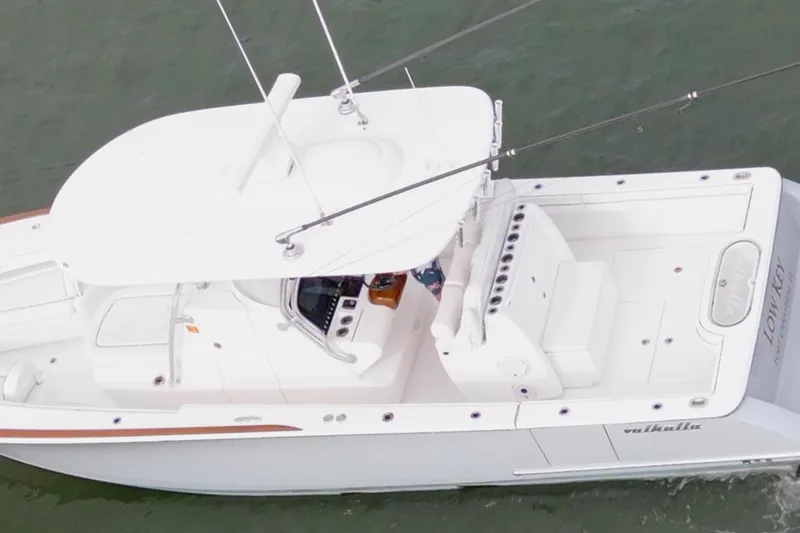 Low Key Yacht Photos Pics Aerial view of 2021 Valhalla V-33 boat on water, featuring sleek white design.