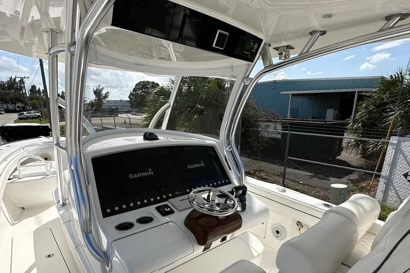 Low Key Yacht Photos Pics Valhalla V-33 2021 boat cockpit with Garmin navigation system and steering wheel.