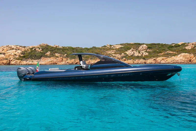 Granturismo 14.0 X Yacht Photos Pics 2024 Lomac GranTurismo 14.0 boat on clear turquoise water near rocky coastline.