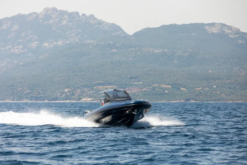 Granturismo 14.0 X Yacht Photos Pics 2024 Lomac GranTurismo 14.0 cruising on the sea with mountainous backdrop.