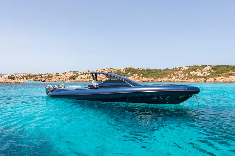 Granturismo 14.0 X Yacht Photos Pics 2024 Lomac GranTurismo 14.0 yacht on clear turquoise water near rocky coastline.