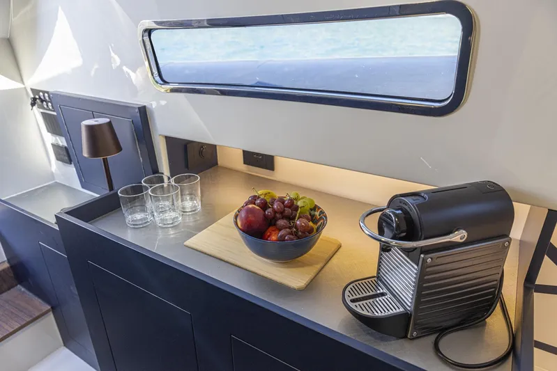 Granturismo 14.0 X Yacht Photos Pics Modern yacht interior with fruit bowl, coffee machine, and glasses on counter. Lomac GranTurismo 14.0, 2024.