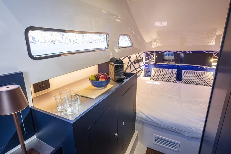 Granturismo 14.0 X Yacht Photos Pics Luxurious interior of 2024 Lomac GranTurismo 14.0 yacht with cozy bed and kitchenette.